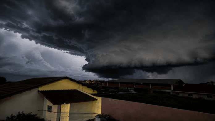 Ilustração por IA mostra uma grande nuvem de tempestade avançando sobre casas em uma área residencial.